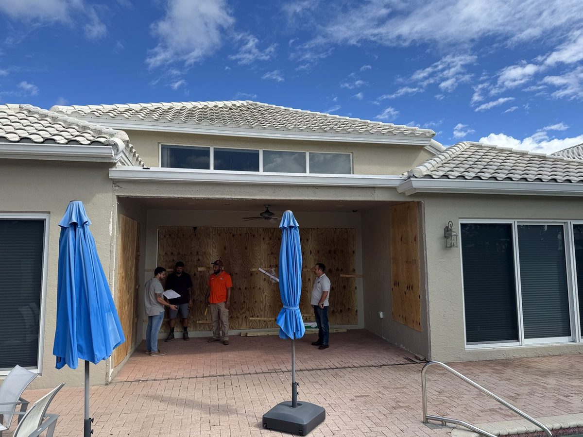Patio at the start of enclosure work, with plywood and framing in place