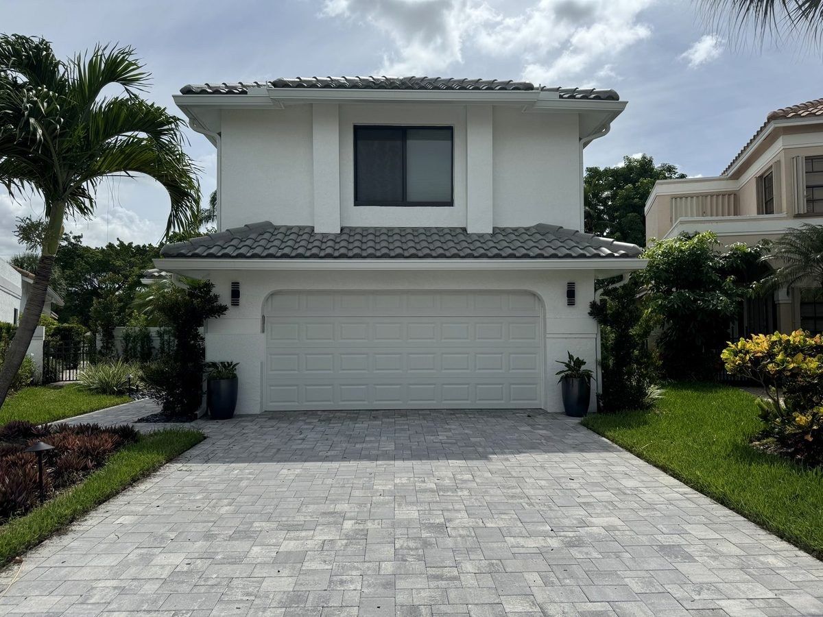 Same home after the completed second-story addition, new roof, and driveway